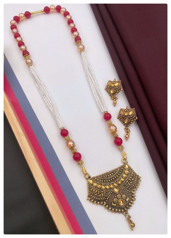 A beautiful gold necklace set with matching earrings