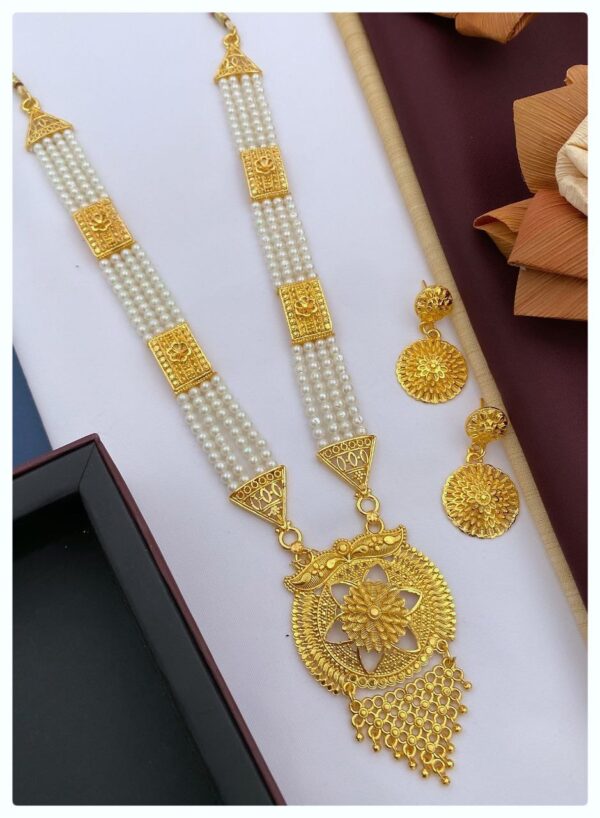 A beautiful gold necklace set with matching earrings