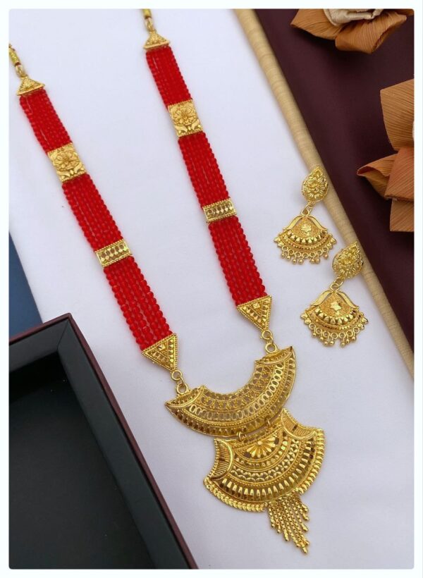 A beautiful gold necklace set with matching earrings