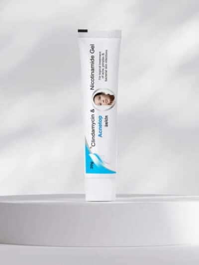 Acnetop acne treatment gel tube placed on a round display platform