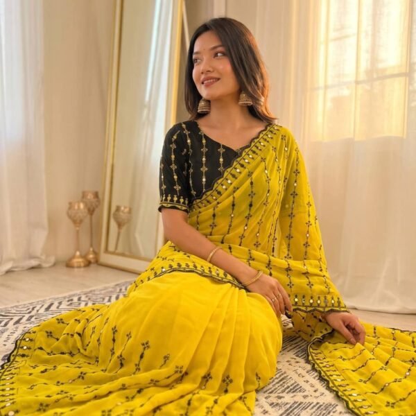 Yellow ethnic saree with elegant mirror work design