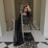 Women wearing black Pakistani wedding wear sharara suit
